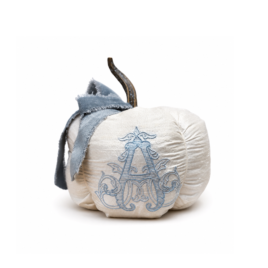 Chateau ivory silk personalized pumpkin with blue velvet bow centered on a white background