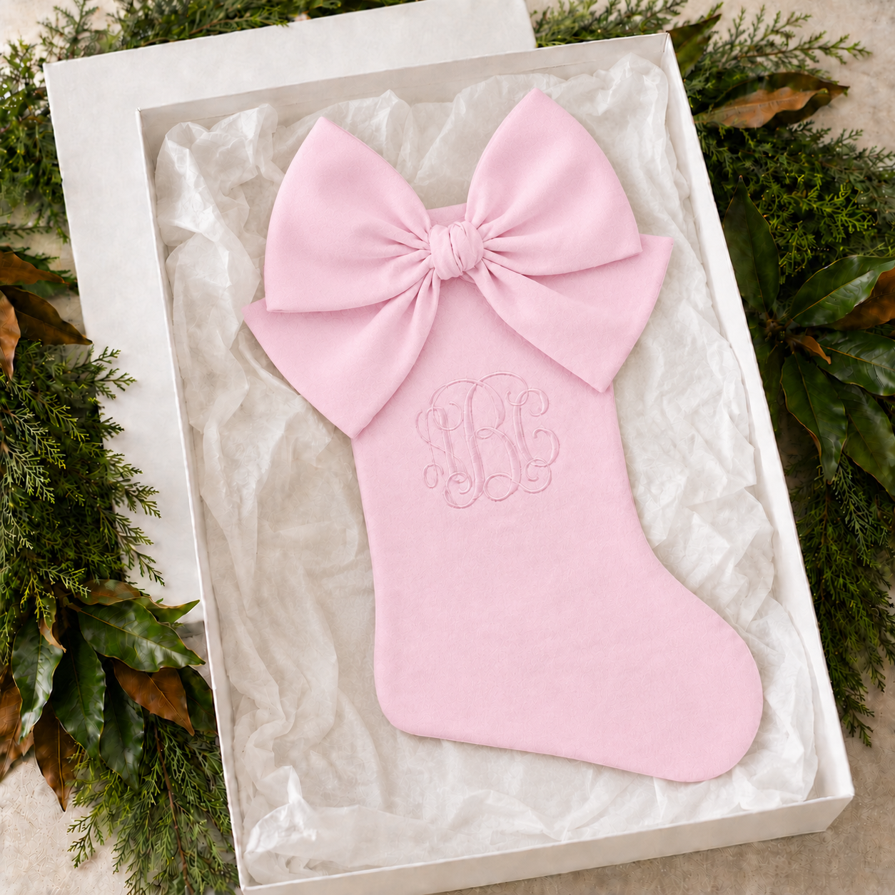 Personalized pink cotton piqué Christmas stocking with bow in a white gift box