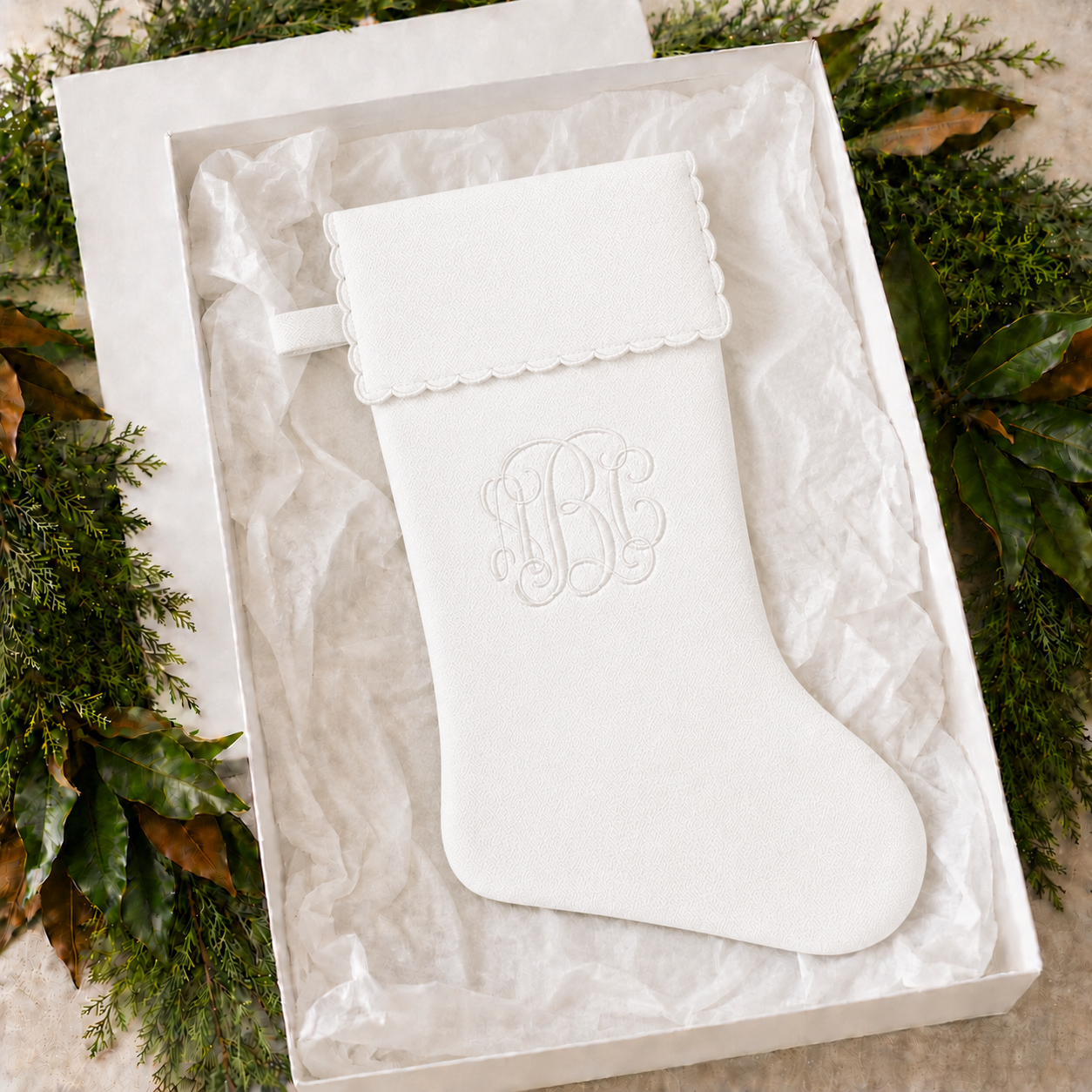 Personalized white cotton piqué Christmas stocking with scalloped cuff in a gift box