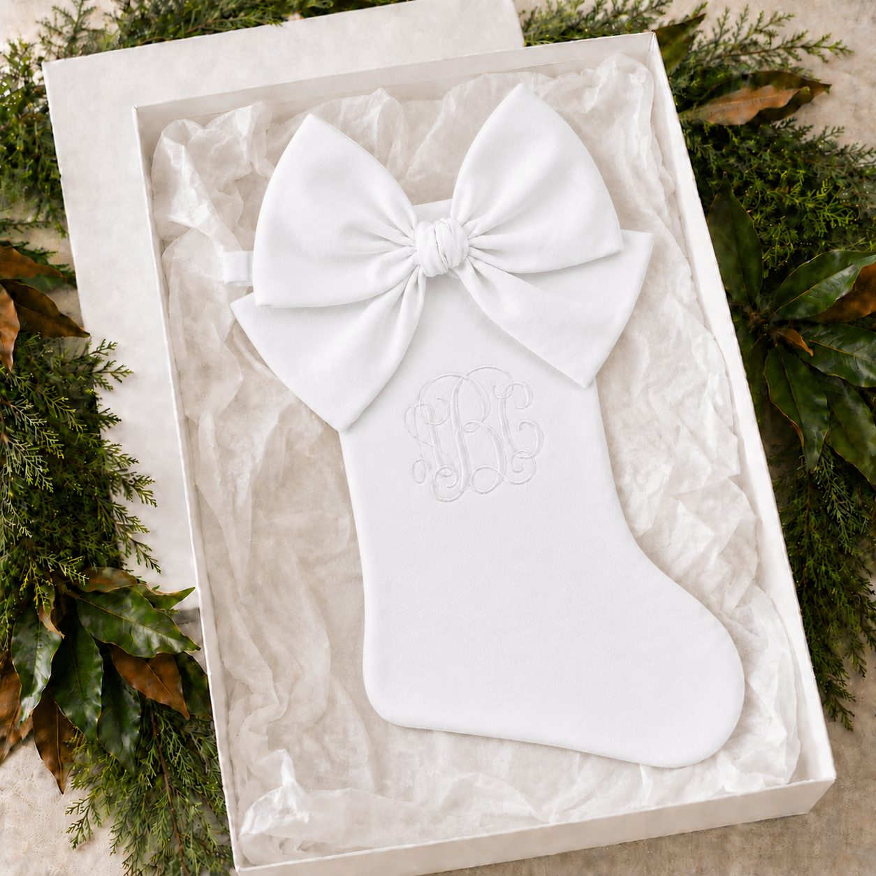 Personalized white cotton piqué Christmas stocking with white bow in a gift box